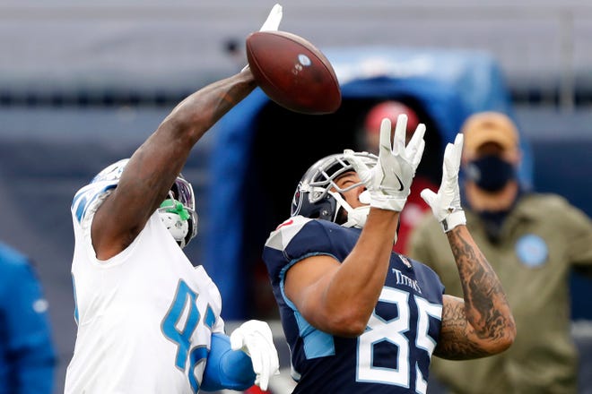 Tight ending MyCole Pruitt (85) of Tennessee Titans failed to complete Jayron Kearse (42) security pass from Detroit Lions during the first quarter of the match at Nissan Stadium on December 20, 2020 in Nashville, Tennessee.