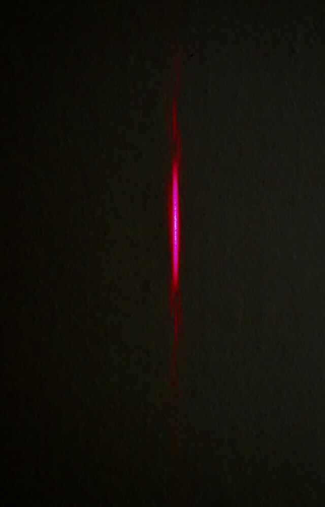 The laser light passing through the individual horizontal slit is diffused vertically