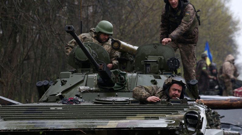 Ukrainian soldiers stand on their armoured personnel carrier (APC), not far from the front-line in the Izyum district of the Kharkiv region, Ukraine, on April 18.